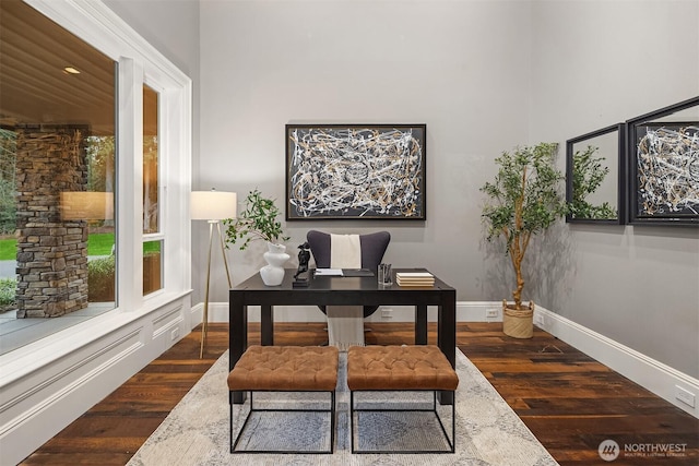 home office featuring baseboards and wood finished floors