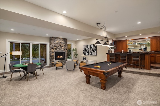 game room featuring light carpet, wet bar, a fireplace, and recessed lighting