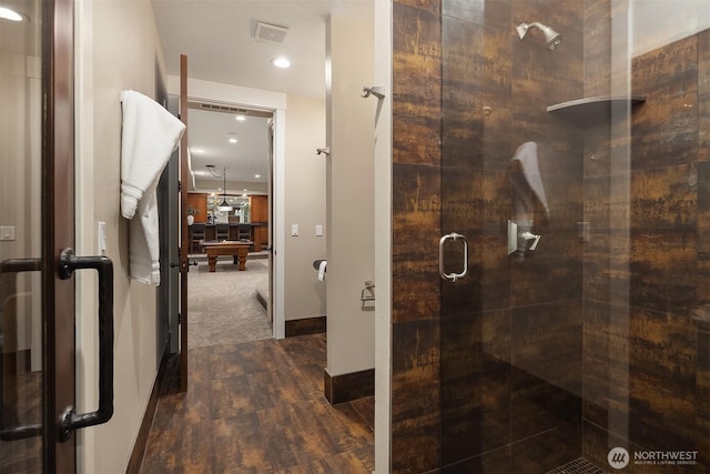 full bathroom featuring visible vents, a shower stall, baseboards, and wood finished floors