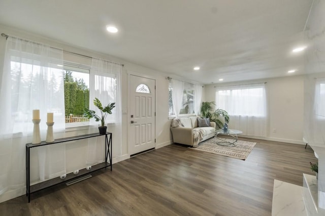 foyer entrance featuring baseboards, dark wood-style flooring, and recessed lighting