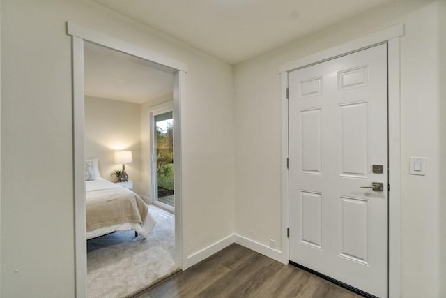 interior space with dark wood-style flooring and baseboards