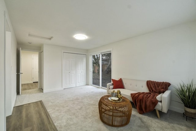 sitting room with carpet and baseboards