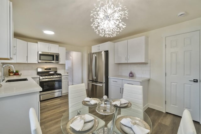 kitchen with white cabinets, stainless steel appliances, and a sink