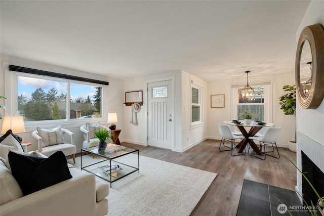 living room featuring light wood-type flooring and baseboards