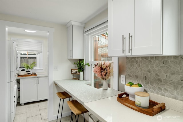 bar with freestanding refrigerator and backsplash