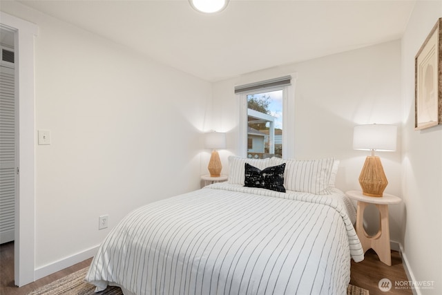 bedroom featuring dark wood-style floors and baseboards