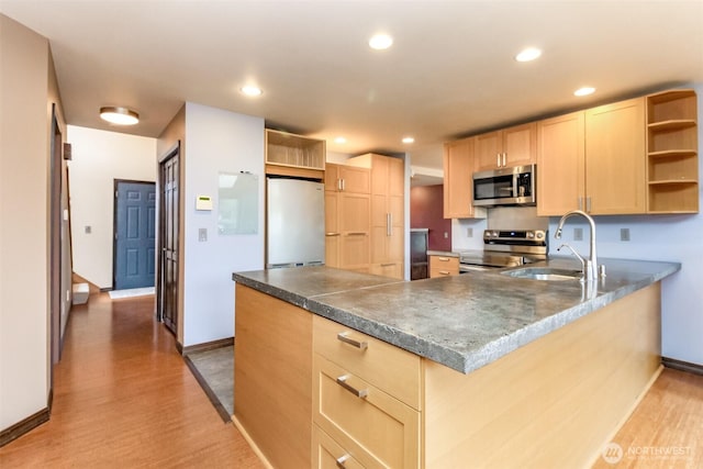 kitchen featuring a peninsula, light brown cabinets, appliances with stainless steel finishes, and open shelves