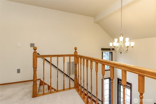 stairway with a healthy amount of sunlight, carpet, visible vents, and a notable chandelier