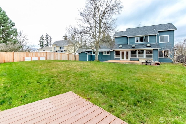 back of house featuring a fenced backyard, a yard, and a wooden deck