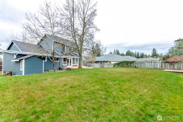 view of yard with a deck and fence