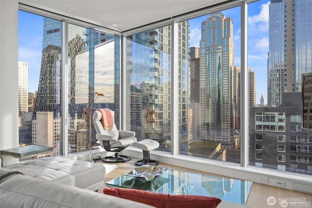 interior space featuring floor to ceiling windows, a city view, and wood finished floors