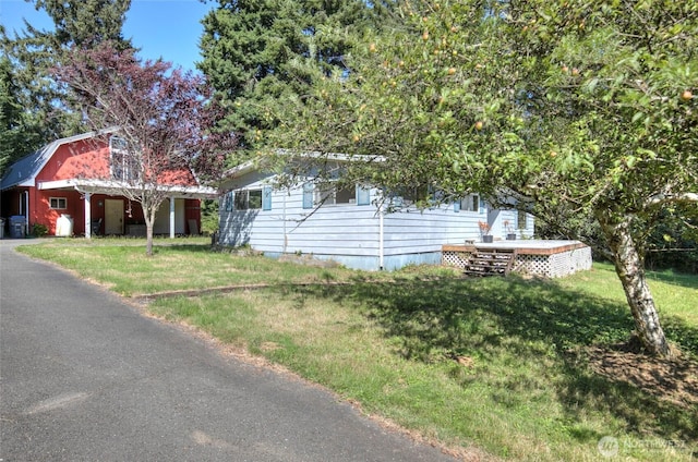 view of front of house featuring a deck and a front lawn