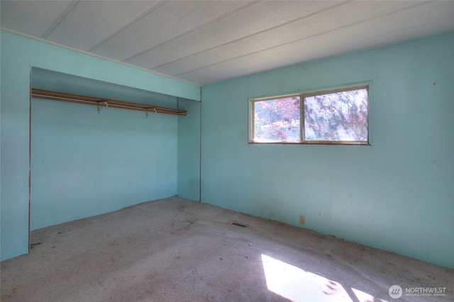 unfurnished bedroom with a closet and carpet flooring