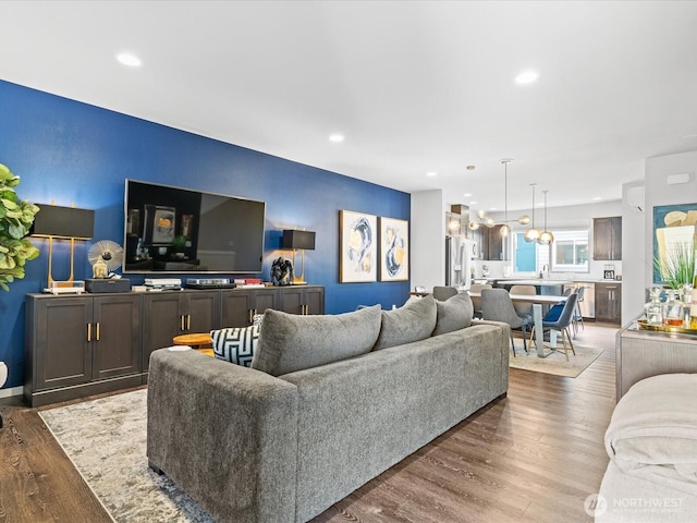 living area with wood finished floors and recessed lighting