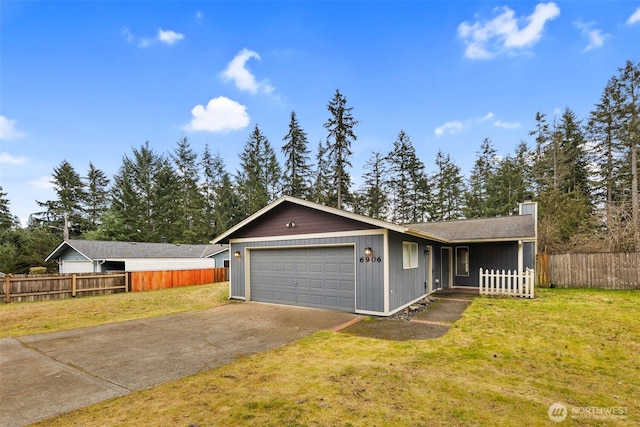 ranch-style home with concrete driveway, fence, and a front lawn