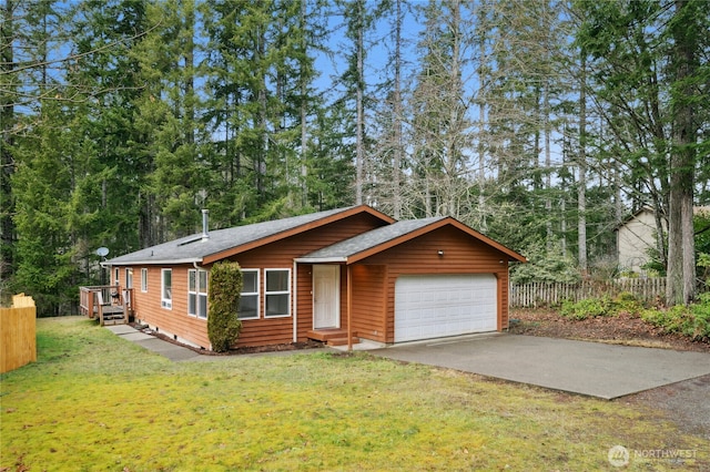 view of front of home featuring a garage, driveway, a front lawn, and fence