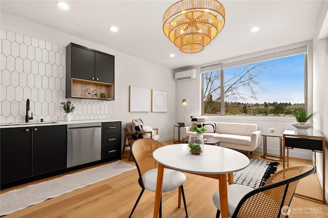 dining room with baseboards, a wall unit AC, light wood-style flooring, a chandelier, and recessed lighting