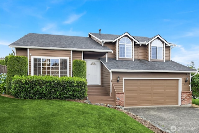 3802 Carpenter St, Mount Vernon, WA 98274 - tri-level home featuring a front lawn, asphalt driveway, brick siding, and an attached garage