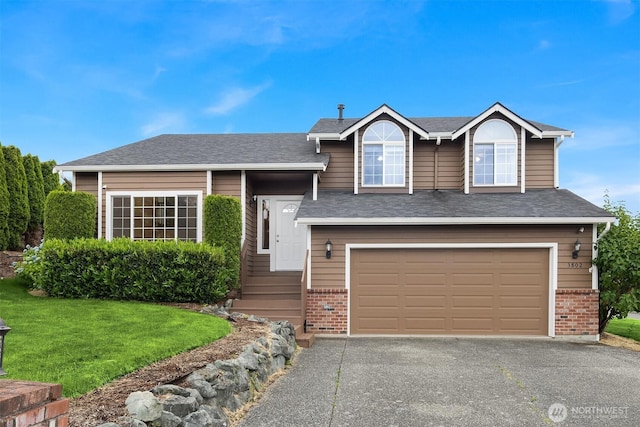 3802 Carpenter St, Mount Vernon, WA 98274 - split level home with a garage, brick siding, driveway, a front lawn, and roof with shingles