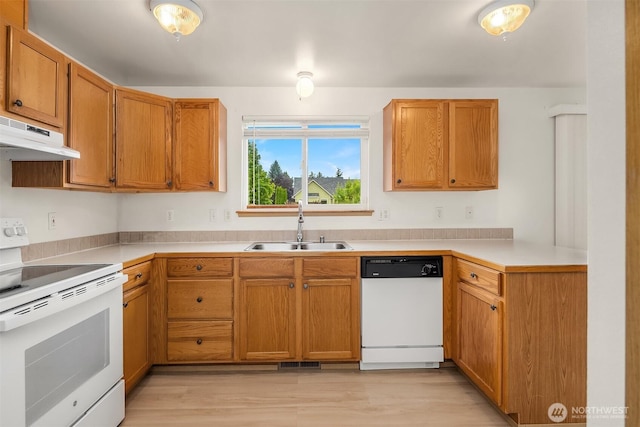 3802 Carpenter St, Mount Vernon, WA 98274 - kitchen featuring white appliances, under cabinet range hood, light wood-style flooring, light countertops, and brown cabinetry