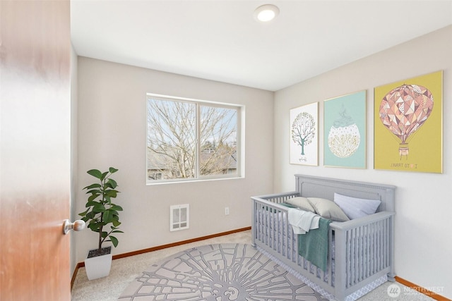 carpeted bedroom featuring baseboards and visible vents