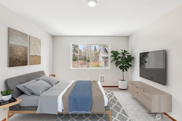 carpeted bedroom with visible vents and baseboards