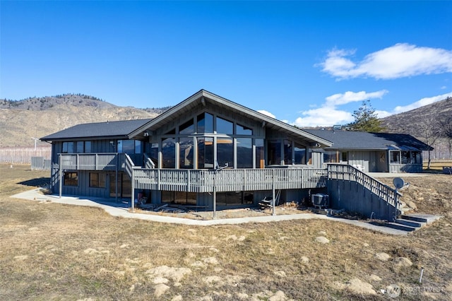 back of house featuring stairway and a deck with mountain view