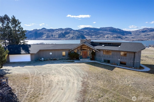 view of front of property featuring a mountain view and driveway