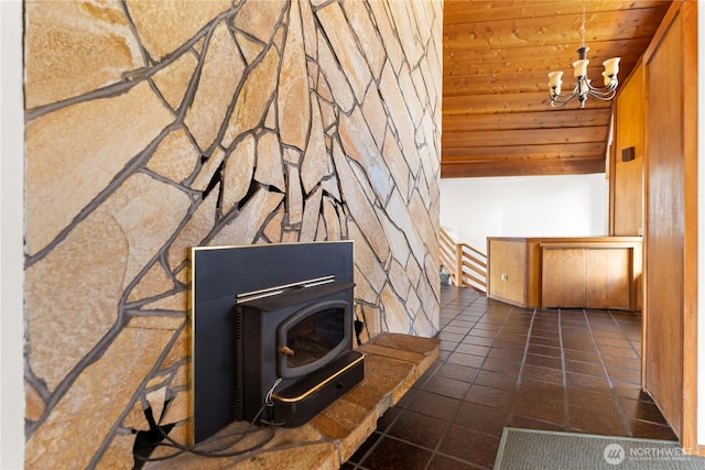 interior space featuring tile patterned floors, an inviting chandelier, wooden ceiling, and a wood stove