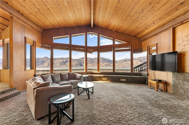 living room with wooden ceiling, a mountain view, and carpet floors