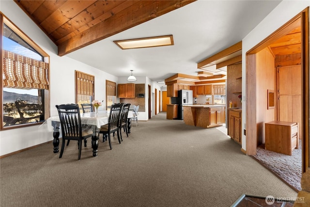 dining room with beam ceiling, baseboards, wooden ceiling, and light carpet