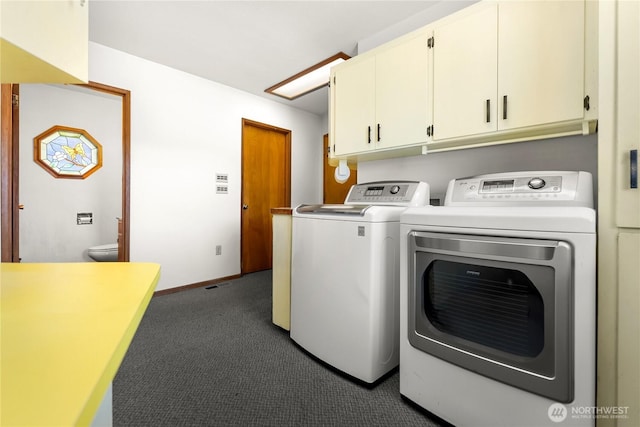 clothes washing area with baseboards, cabinet space, dark colored carpet, and washing machine and clothes dryer