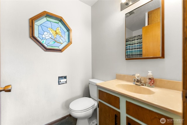 bathroom with toilet and vanity