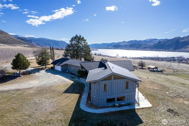 bird's eye view with a water and mountain view