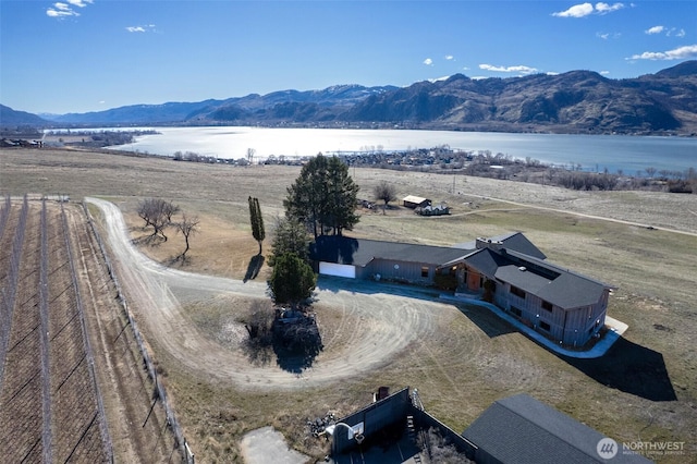 drone / aerial view with a water and mountain view