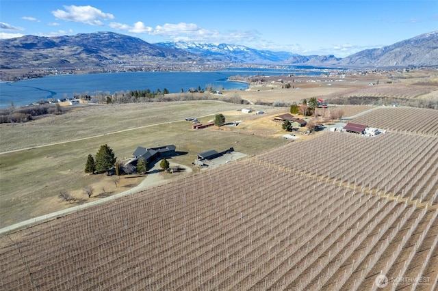 drone / aerial view featuring a water and mountain view