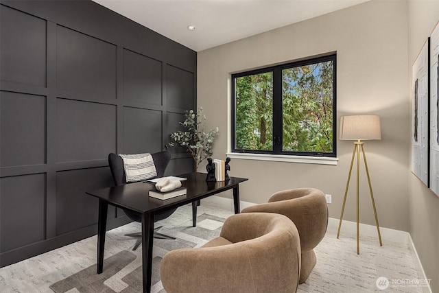 office area featuring baseboards, recessed lighting, and a decorative wall