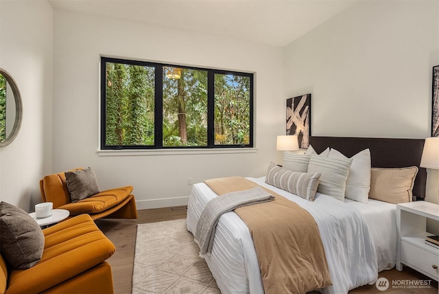 bedroom featuring wood finished floors and baseboards