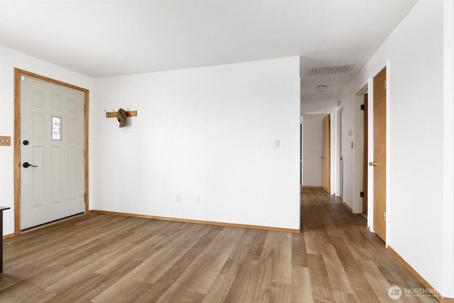 entrance foyer with light wood-style floors, baseboards, and visible vents