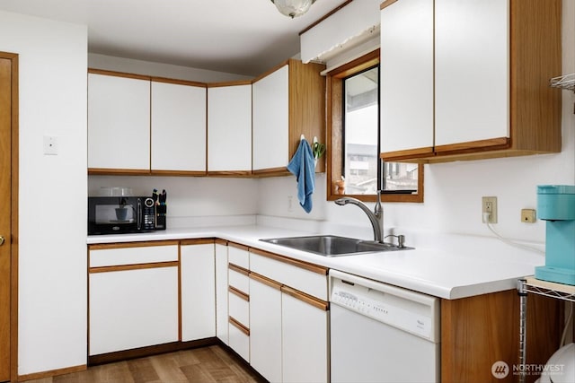 kitchen featuring a sink, white cabinetry, black microwave, and dishwasher