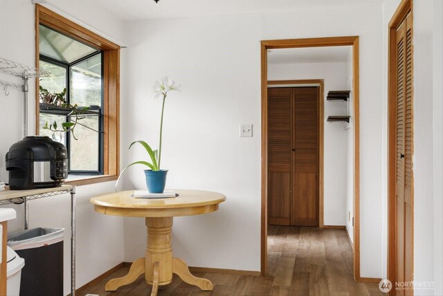 interior space featuring baseboards and wood finished floors