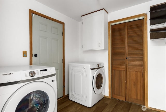 laundry room with cabinet space, dark wood-style flooring, and washer and dryer