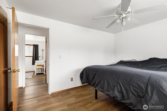 bedroom with ceiling fan, baseboards, and wood finished floors