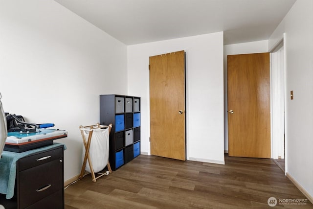 home office featuring baseboards and wood finished floors