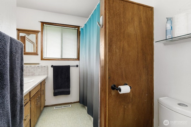 full bath with visible vents, vanity, and toilet