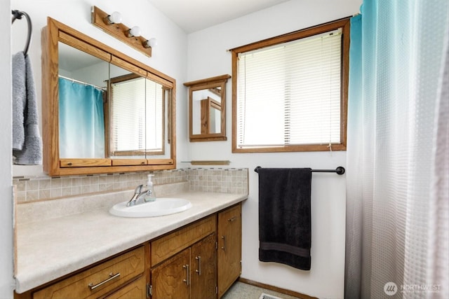 full bathroom with backsplash and vanity