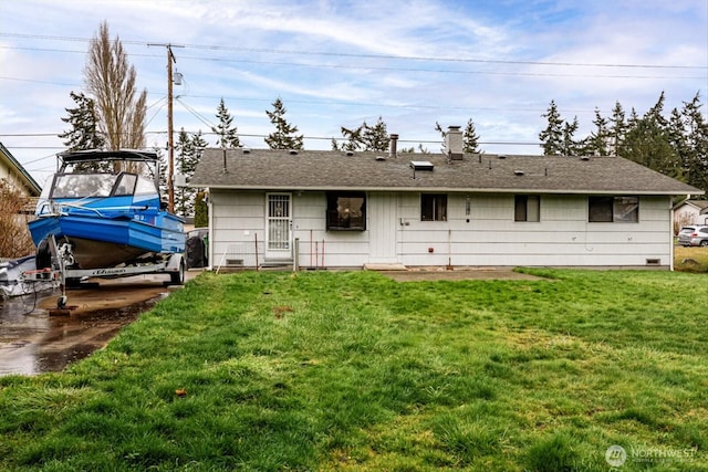 rear view of house featuring a lawn