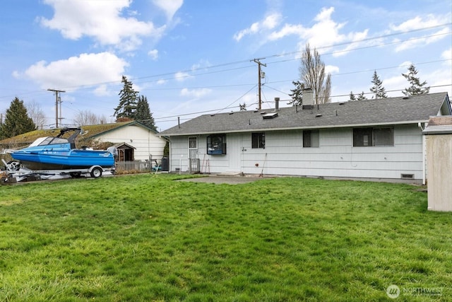 back of house with a shingled roof, crawl space, and a yard