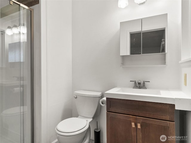 full bath featuring vanity, toilet, and a shower stall
