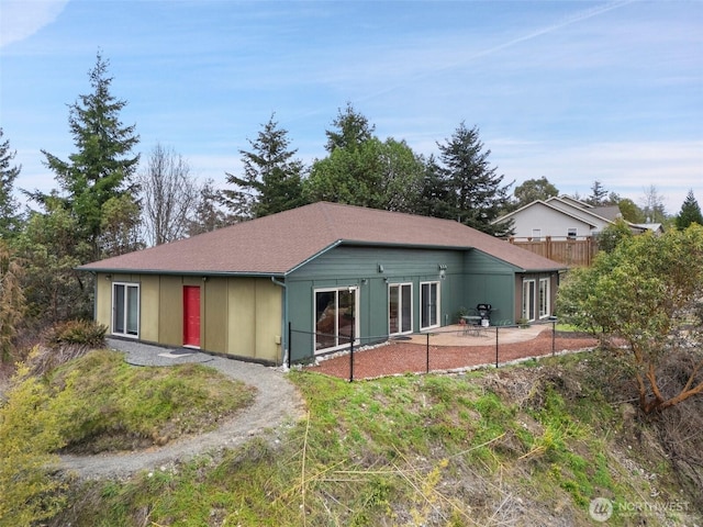 back of property featuring a patio and fence